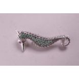 A 925 silver brooch set with emeralds and rubies in the form of a seahorse, 2" long