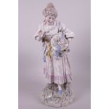 A large C19th porcelain figurine of a girl with a floral bonnet, 15" high, A/F