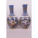 A pair of Continental mallet shaped vases with hand painted floral decoration and gilt