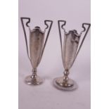 A pair of small hallmarked silver two handled specimen vases (folded), 4¾" high