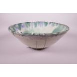 A green glazed slipware pottery bowl, A/F repair, 15" diameter