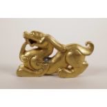 A Chinese gilt bronze scroll weight in the form of a dragon, 3½" long