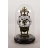 A brass skeleton clock with oval enamel dial, the movement striking on a gong, 11½" high