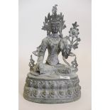 An Oriental patinated bronze figure of Buddha seated upon a stylised lotus throne, 15" high