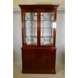 A mahogany display cabinet with dentil moulded cornice, over two astragal glazed doors and two