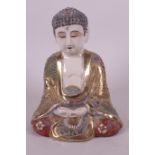A Japanese Meiji period Satsuma figurine of Buddha seated in meditation wearing a brightly