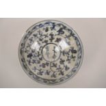 A Chinese blue and white pottery dish with scrolling floral decoration, 4 character mark to