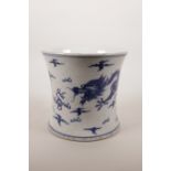 A Chinese blue and white porcelain brush pot of waisted form decorated with two dragons chasing