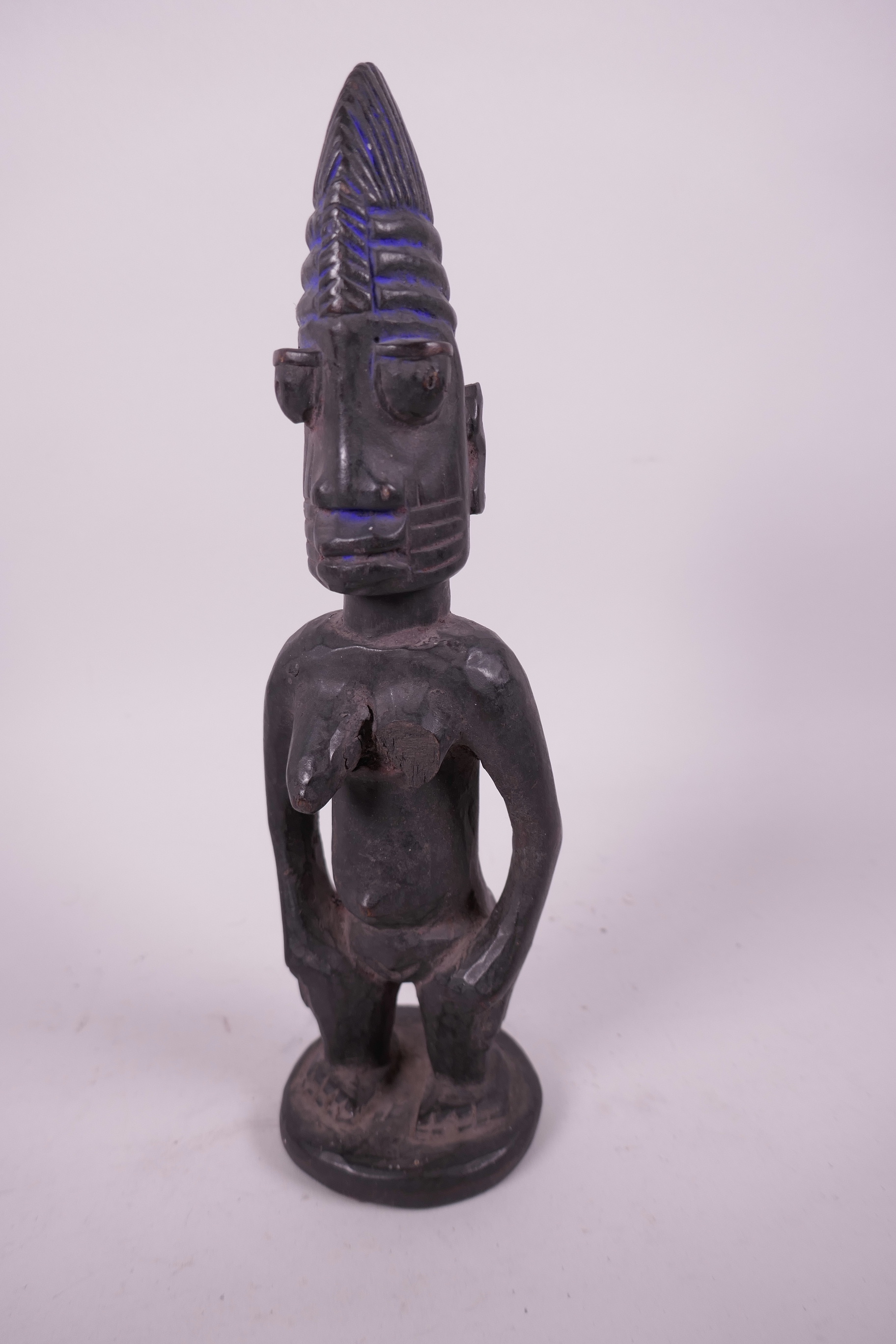 An African carved wood fertility figure, 10"