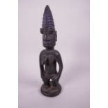 An African carved wood fertility figure, 10"