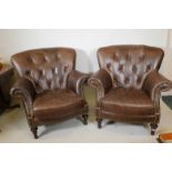 A pair of brown leather button back tub chairs, 40" high