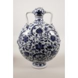 A Chinese blue and white porcelain two handled moon flask with scrolling lotus flower decoration,