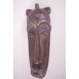 An African carved wood tribal mask, 20½" long