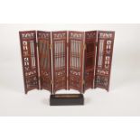 A Chinese pierced hardwood six fold concertina table screen together with a hardwood trinket box,