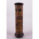 A Chinese hardwood cylinder incense burner with carved and pierced dragon decoration, 10" high