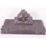 A cast iron table desk stand, embossed with fruiting vines, 11" wide