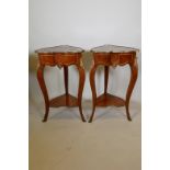 A pair of inlaid walnut, shaped two tier occasional tables with ormolu mounts and marquetry style