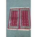 A pair of red ground silk Kashmir runners decorated with a Bokhara design, 27" x 56"