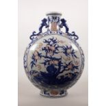 A large Chinese blue and white pottery moon flask with two dragon handles, decorated with peaches,