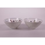 A pair of Chinese doucai porcelain bowls with raised petal decoration to exterior and enamel chicken