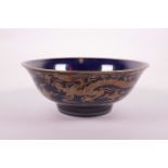 A Chinese blue ground porcelain bowl with copper lustre dragon decoration, 6 character mark to base,