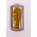 A Chinese silvered metal pendant set with a piece of faux amber containing a scorpion, 3½" long