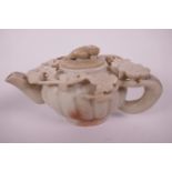 A Chinese carved and pierced soapstone teapot with ribbed body and vine and flower decoration, 5"