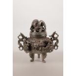 A Chinese silvered metal censer and cover, raised on tripod supports with two handles and dragon