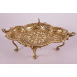 A gilt bronze bonbon dish with raised Renaissance revival decoration, on four stylised swan