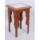 A Moorish style oak occasional table with inset marble top, 12" x 12" x 19"