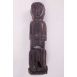 An Indonesian carved wood male figure, 12" high