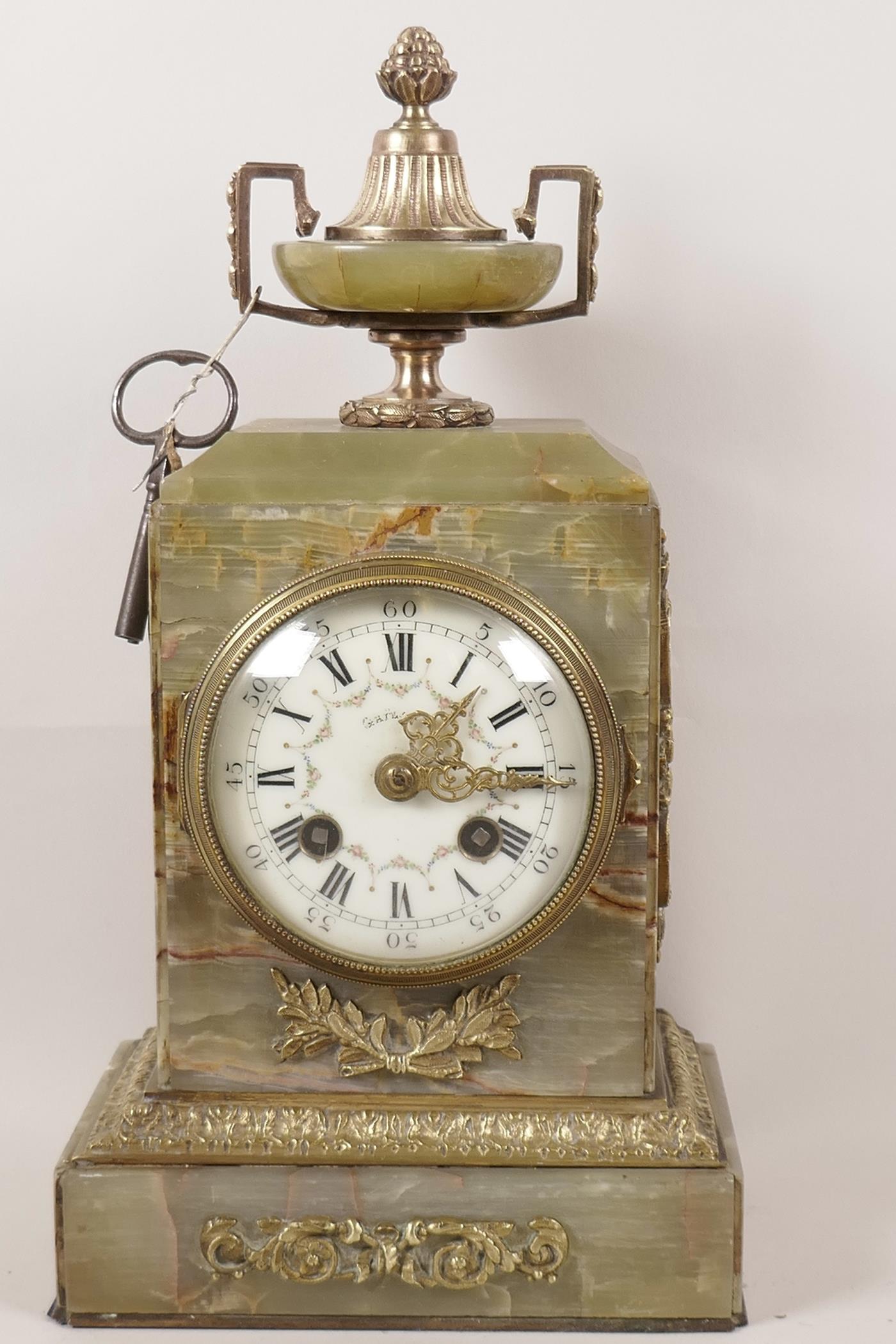 An onyx and ormolu mounted French mantel clock with floral painted white enamel dial and Roman