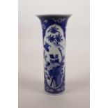 A Chinese blue and white porcelain cylinder vase with a flared rim, with decorative panels depicting