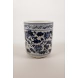 A Chinese blue and white pottery brush pot with scrolling floral decoration, 4½" x 4" diameter
