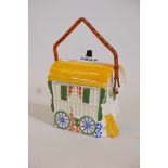 A ceramic biscuit barrel in the form of a gypsy's caravan, 8" high
