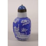 A Chinese blue and white glass snuff bottle with carved decoration of figures in a landscape, 2½"