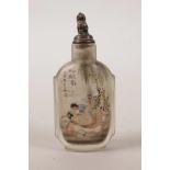 A Chinese reverse painted glass snuff bottle with erotic decoration, character inscription verso,