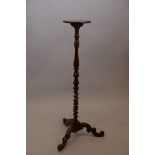 A C19th walnut and mahogany candlestand, with turned and twisted column and shaped supports, 39"