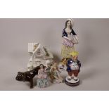 A Staffordshire figurine of a lady with a basket of fish, 9½" high, together with a Staffordshire