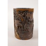 A Chinese bamboo brush pot with carved decoration of figures in a landscape, 5" high