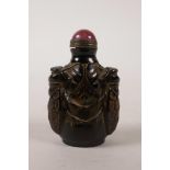 A Chinese faux horn snuff bottle with carved cicada, 3" high
