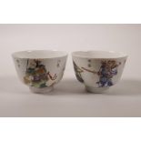 A pair of Chinese polychrome enamelled porcelain tea bowls decorated with two warriors, seal mark to