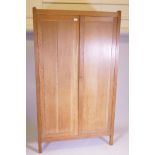 A Heal's 'Letchworth' oak two door wardrobe, the interior with three shelves and hanging space,