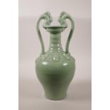 A Chinese green glazed porcelain vase with two dragon shaped handles, seal mark to base, 14" high