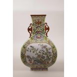A Chinese polychrome porcelain vase with two bat shaped handles, with decorative enamel panels