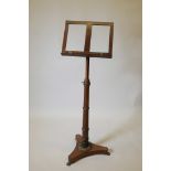 A Regency mahogany adjustable music stand, with ring turned column and ratcheted height