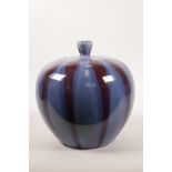 A Chinese pottery jar and cover with a red and blue flambé glaze, 8½" high