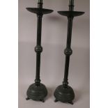 A pair of tall metal candlesticks with green patination finish, 23½"