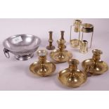 A collection of brass chamber sticks and taper holders, and a French pewter bowl with ring