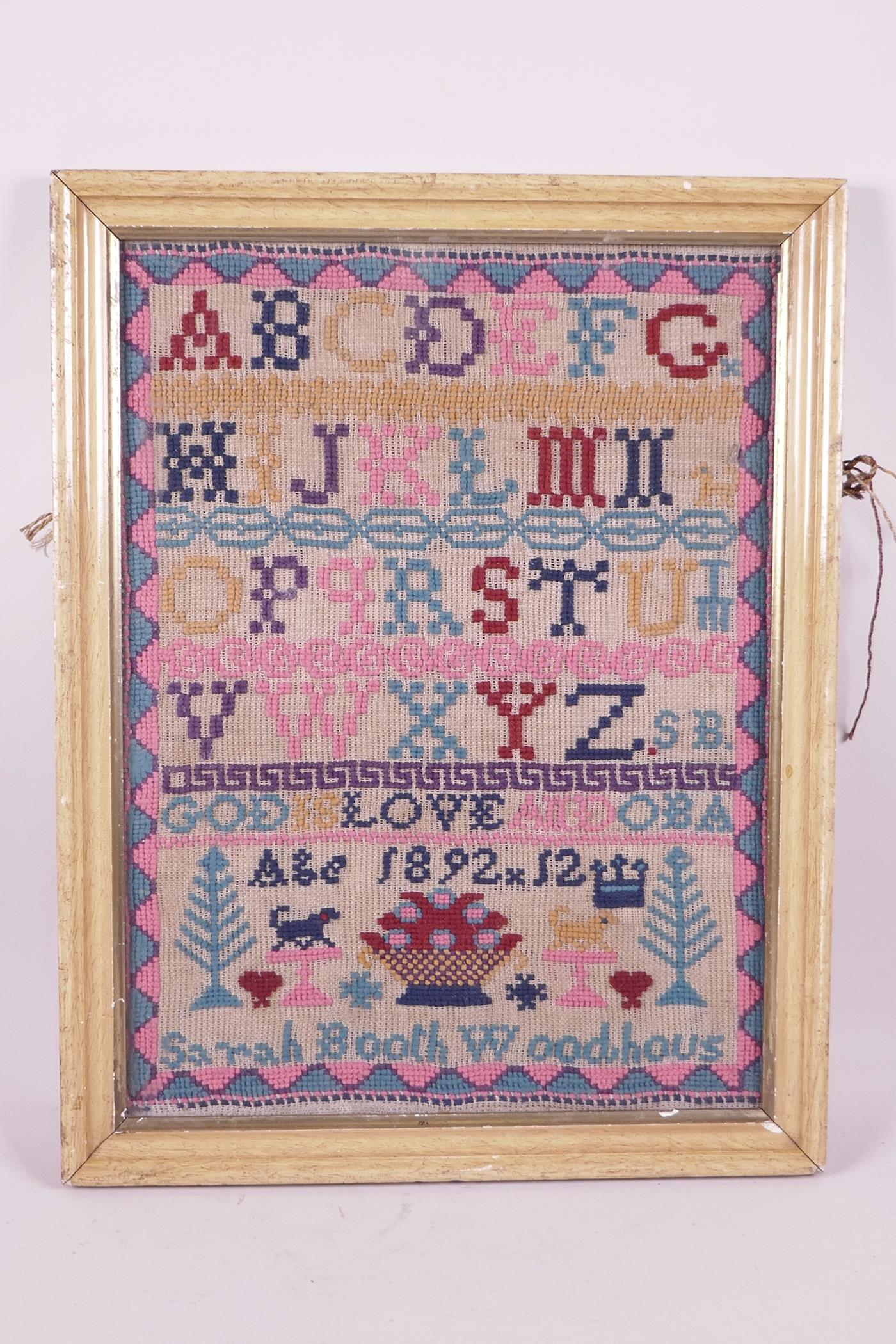A C19th wool sampler, signed Sarah Booth Woodhaus, age 12, dated 1892, 12" x 16"